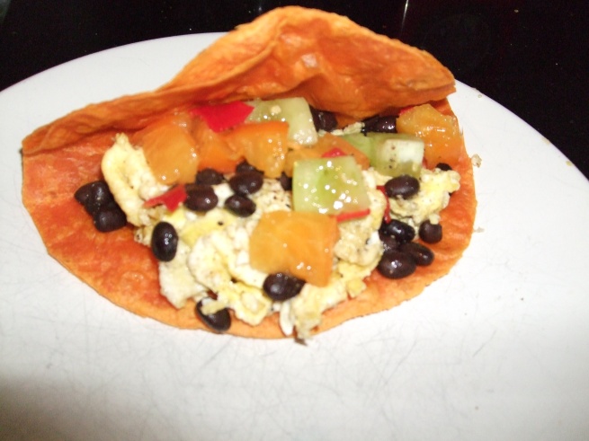 breakfast taco with scrambled egg, black beans, and mixed tomato salsa with serrano chile pepper